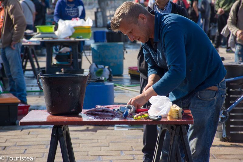 Fisherman cleaning fish at Marseille market