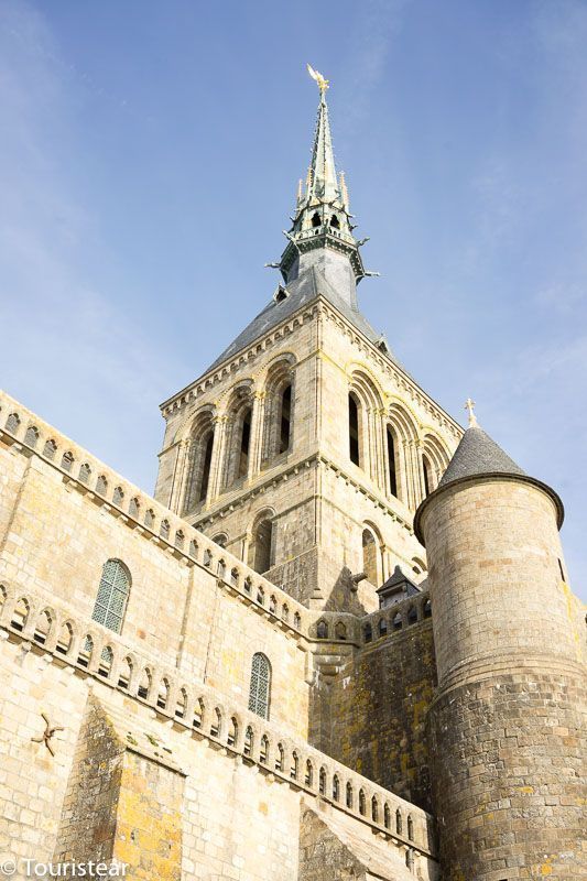 Mont Saint Michel tower in Normandy, France under clear blue skies