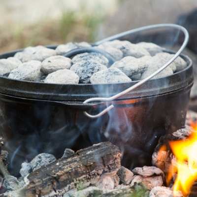 dutch oven on embers for cooking food to eat when camping