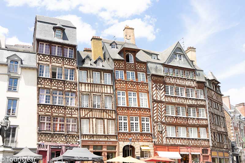 Line of multilevel houses in the Old Town of Rennes, a place to stay when getting to Mont Saint Michel from Paris