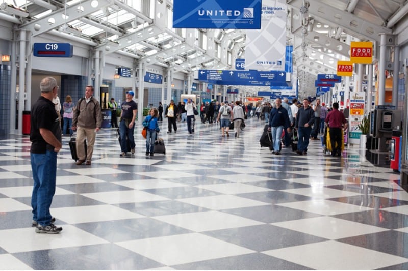 OHare International Airport with people walking with some looking for the rental car counter in Chicago