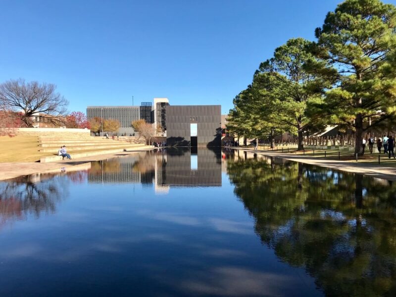 Oklahoma City National Memorial & Museum with park on both sides and a lake in the foreground